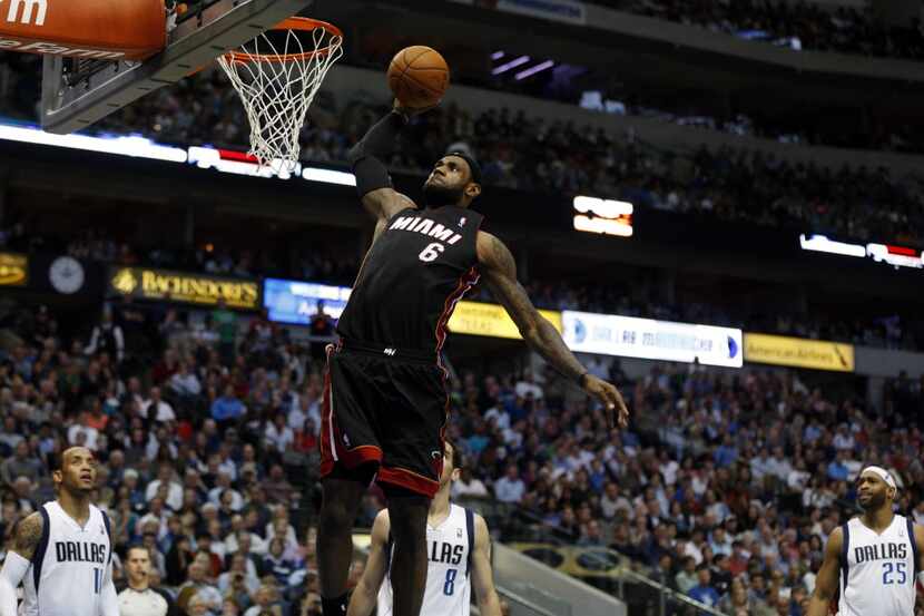 Miami Heat small forward LeBron James (6) dunks the ball as Dallas Mavericks defense watches...