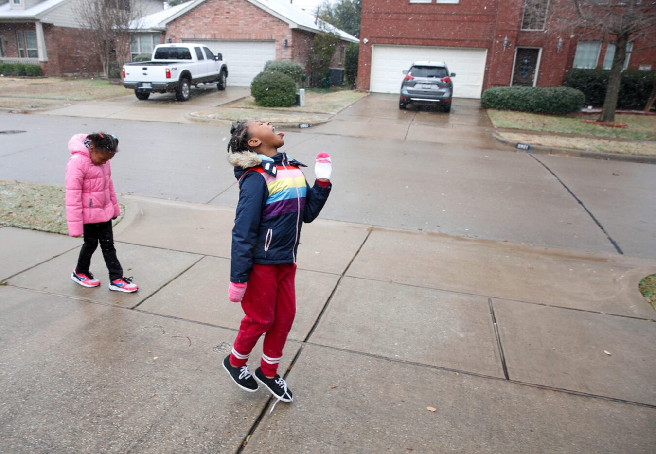 Six-year-old Dasiya Small, left and her sister 7-year-old Damyri Small try to catch...