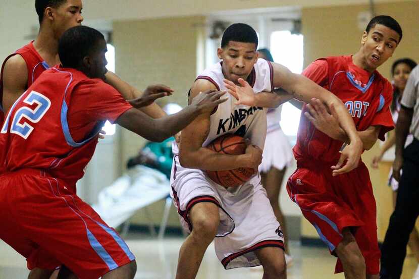 Kimball's Keith Frazier (4) grabs a rebound in front of Carter players (from left) Stephen...