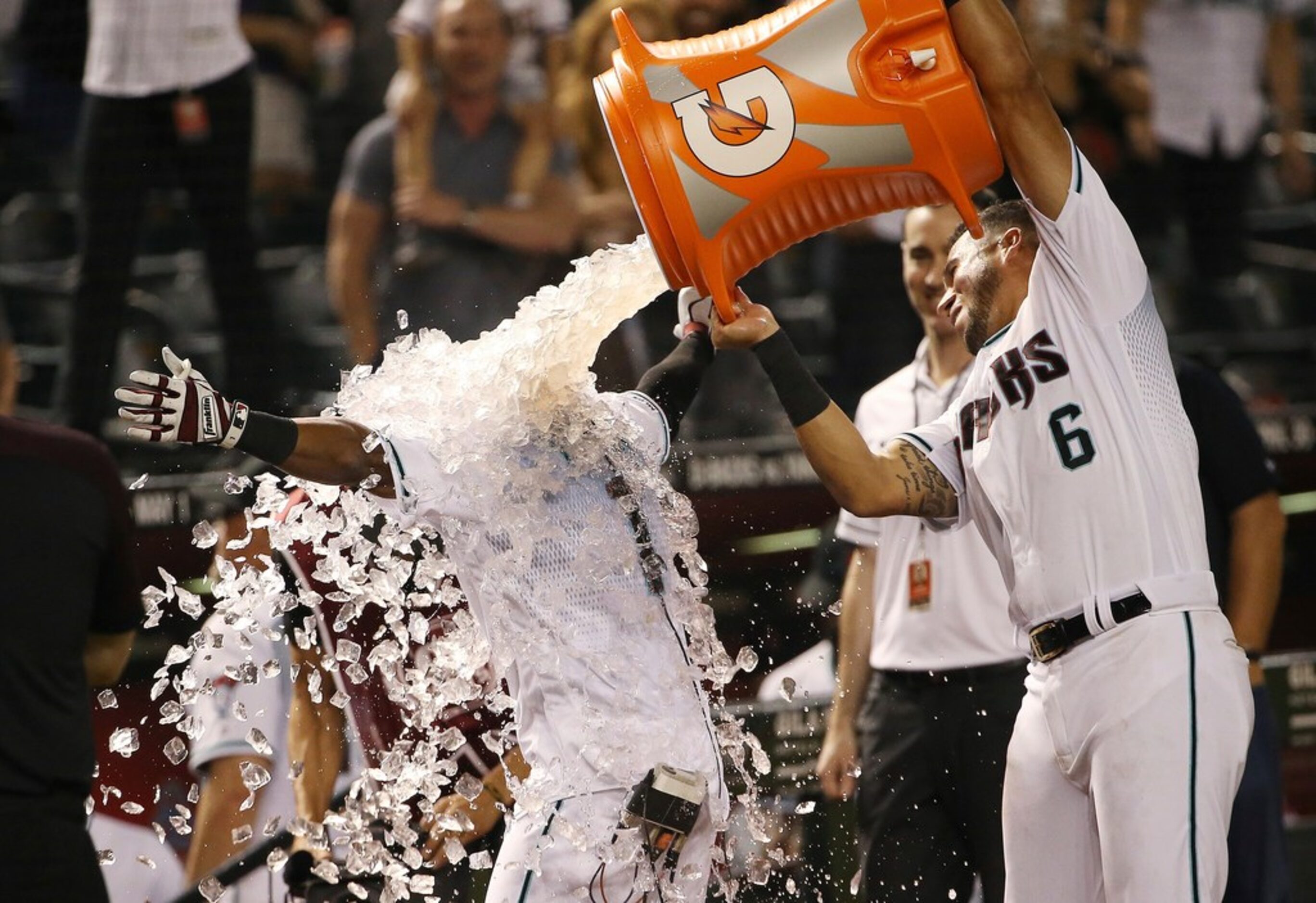 Arizona Diamondbacks' Jarrod Dyson has ice poured over him by David Peralta (6) after...