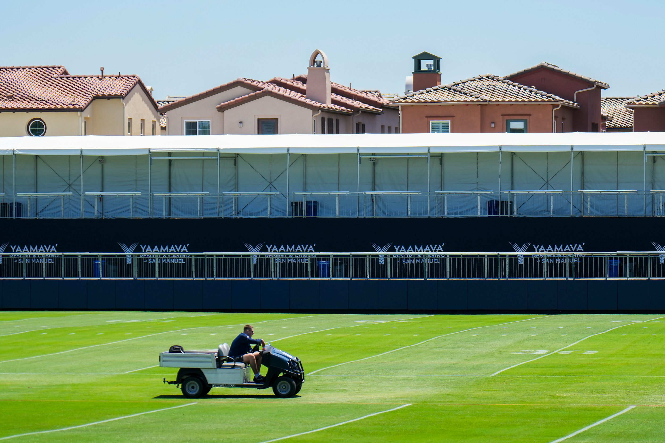 Workers prepare the field for Wednesday’s start of Dallas Cowboys training camp as a newly...