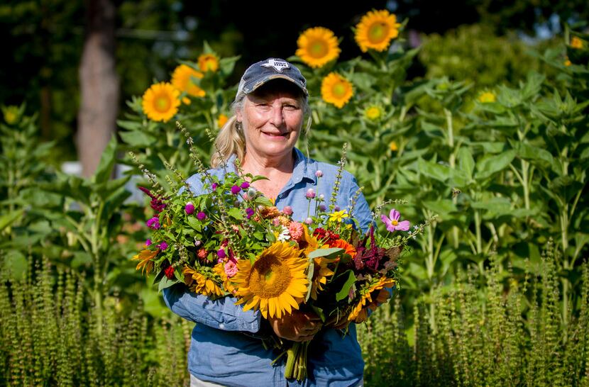 Amanda Vanhoozier of Bishop Hill Farm with a fresh bouquet of cut flowers from her Coppell...