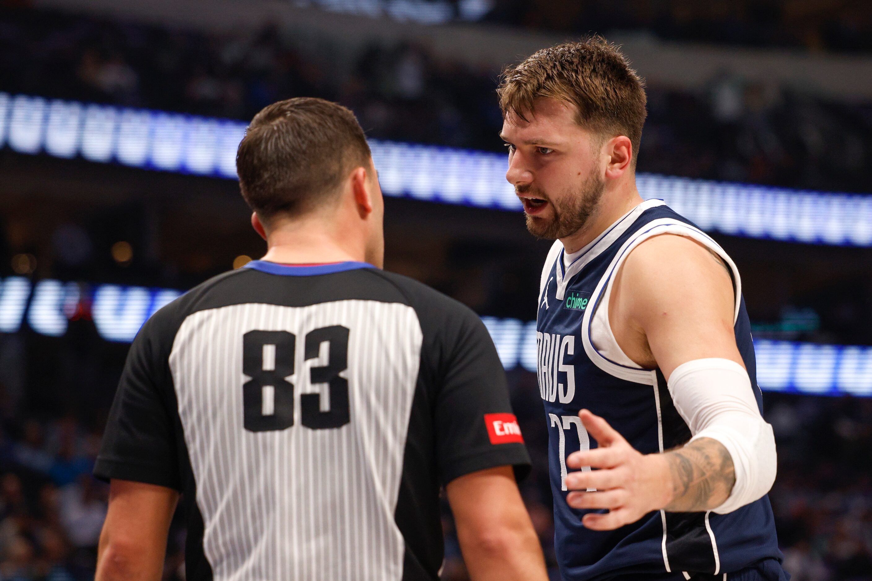 Dallas Mavericks guard Luka Doncic (77) talks with referee Andy Nagy (83) during the first...