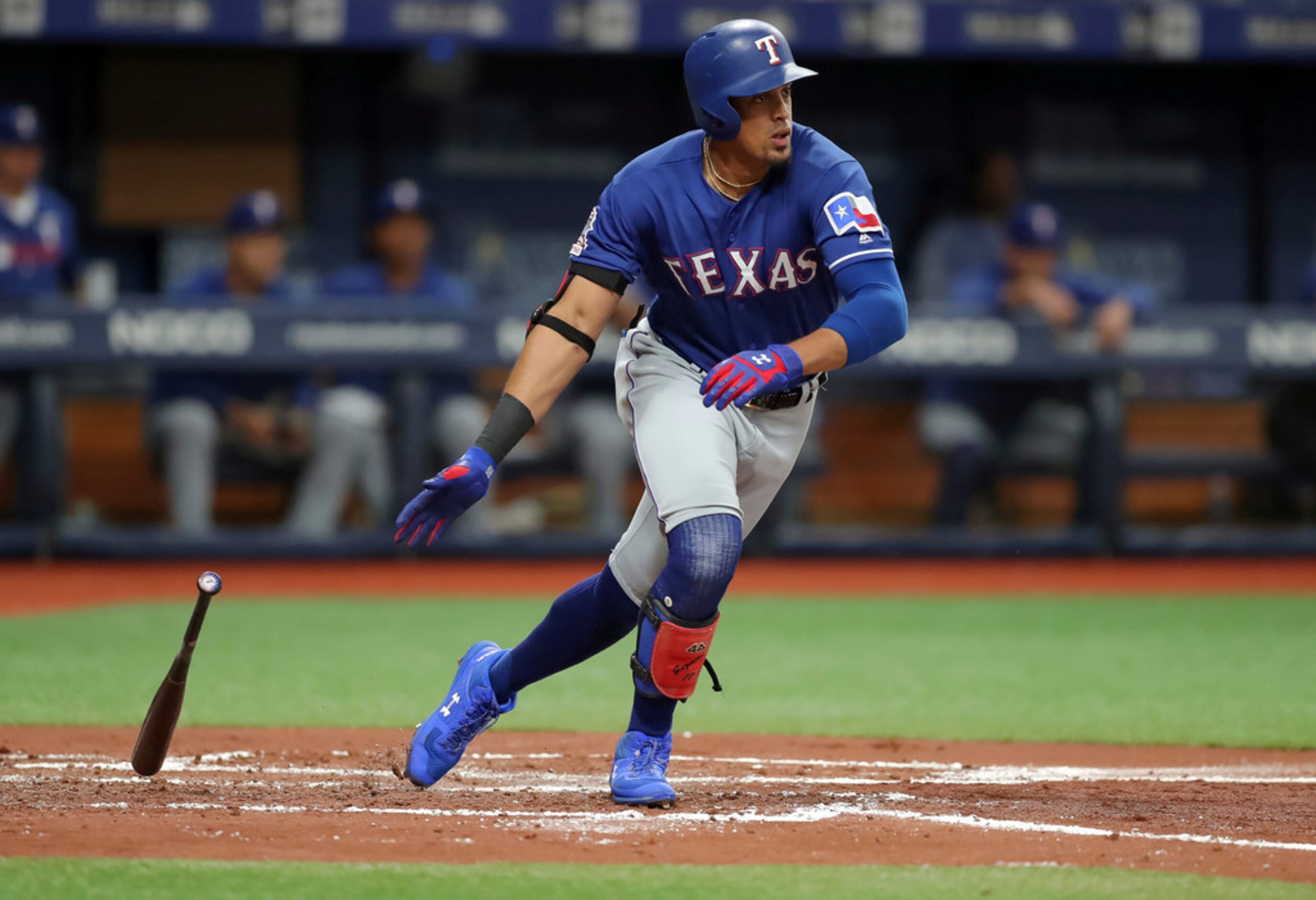 Texas Rangers' Ronald Guzman drops his bat after hitting a two-run double against the Tampa...