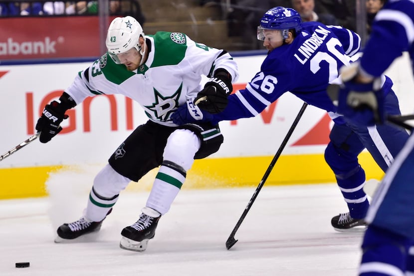 Toronto Maple Leafs center Par Lindholm (26) picks up a penalty for holding Dallas Stars...