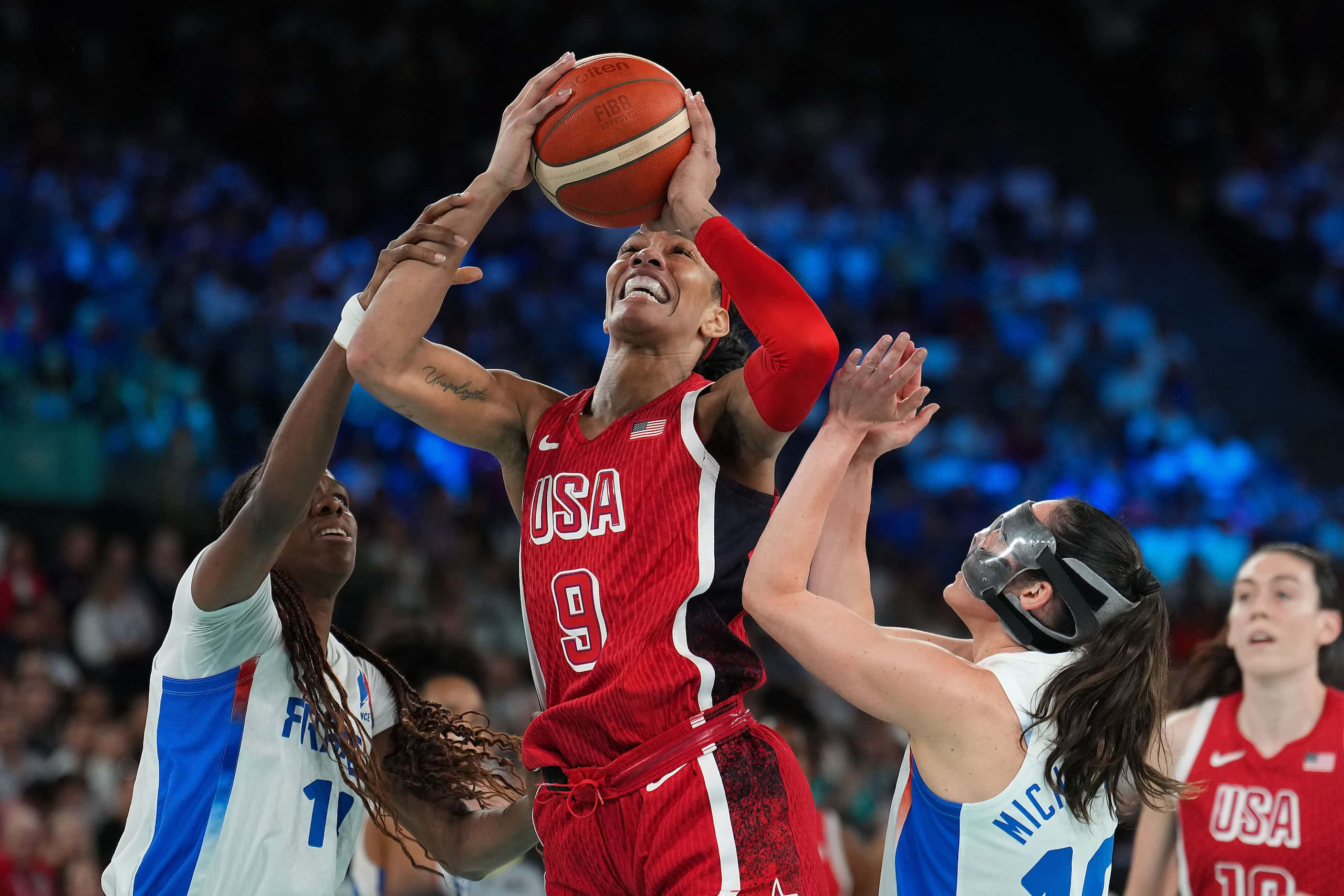 A'Ja Wilson (9) of the United States is fouled by Dominique Malonga (14) of France during...