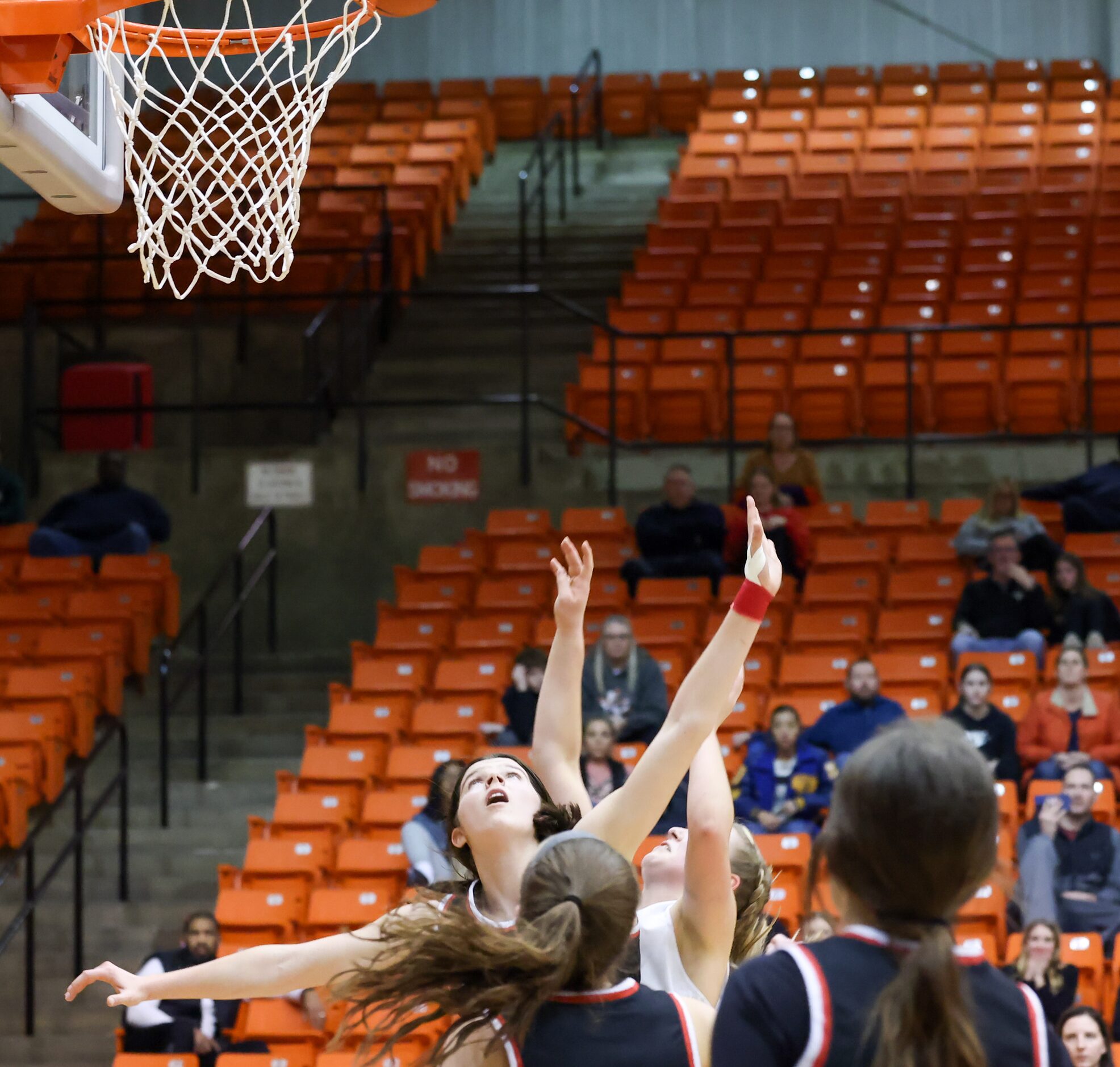 Coppell senior guard Waverly Hassman (11, left) looks up at the ball as she jumps to compete...