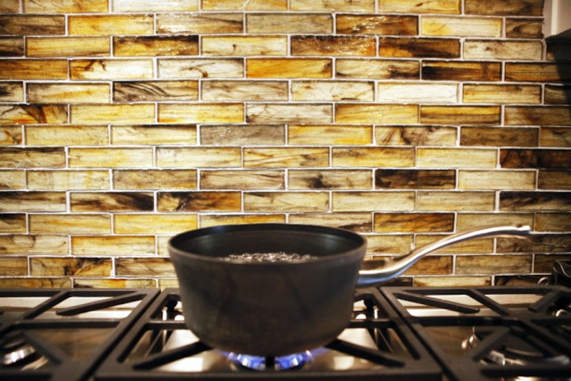 The tiles on the backsplash of this kitchen are made from recycled glass.   The Lakewood...