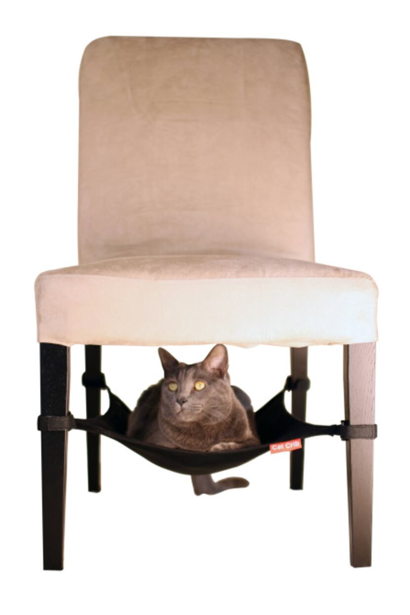Felines can hang out under a table or chair in the space-efficient Cat Crib that attaches to...