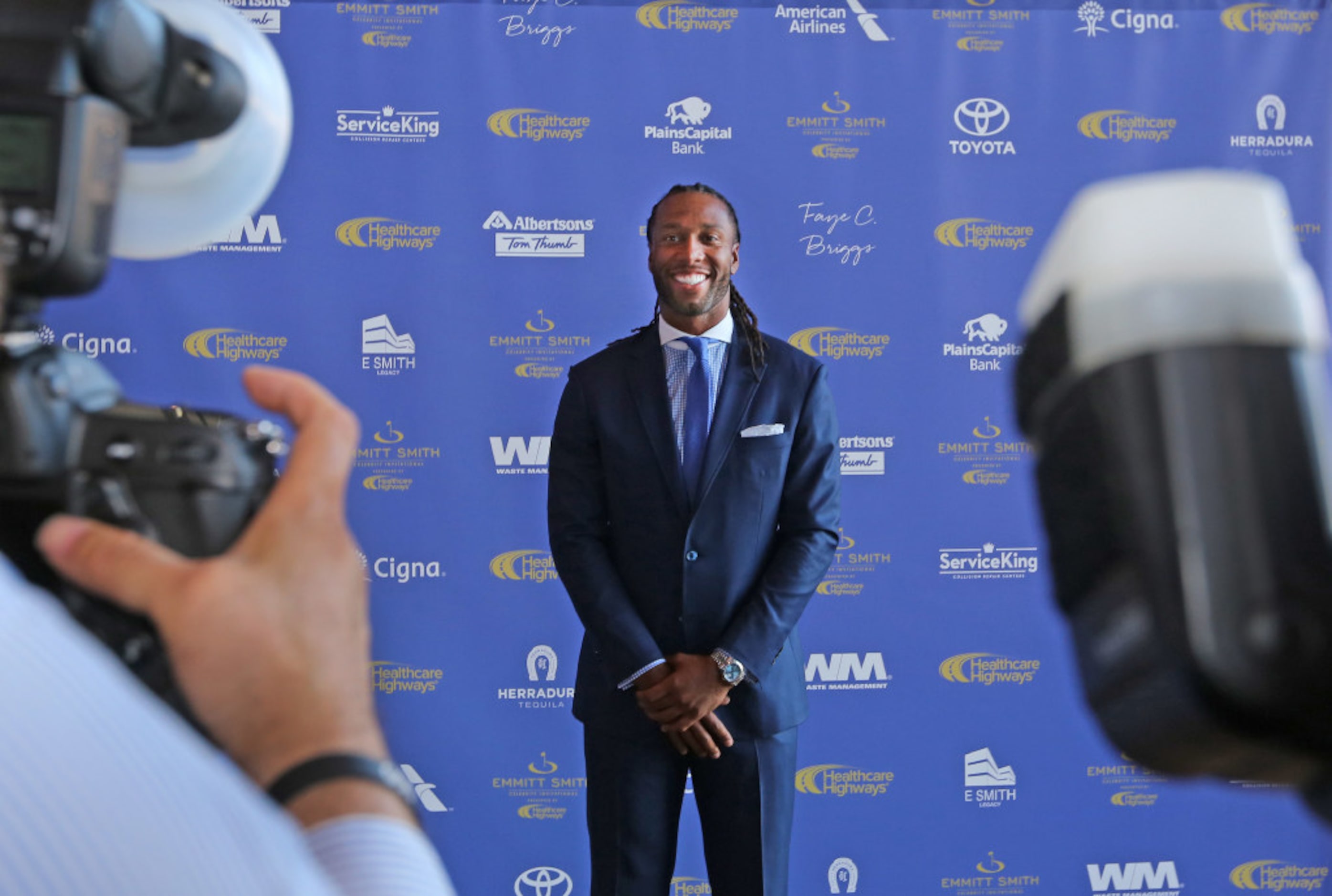 Larry Fitzgerald poses for photographers during the red carpet walk at the 8th Annual Emmitt...