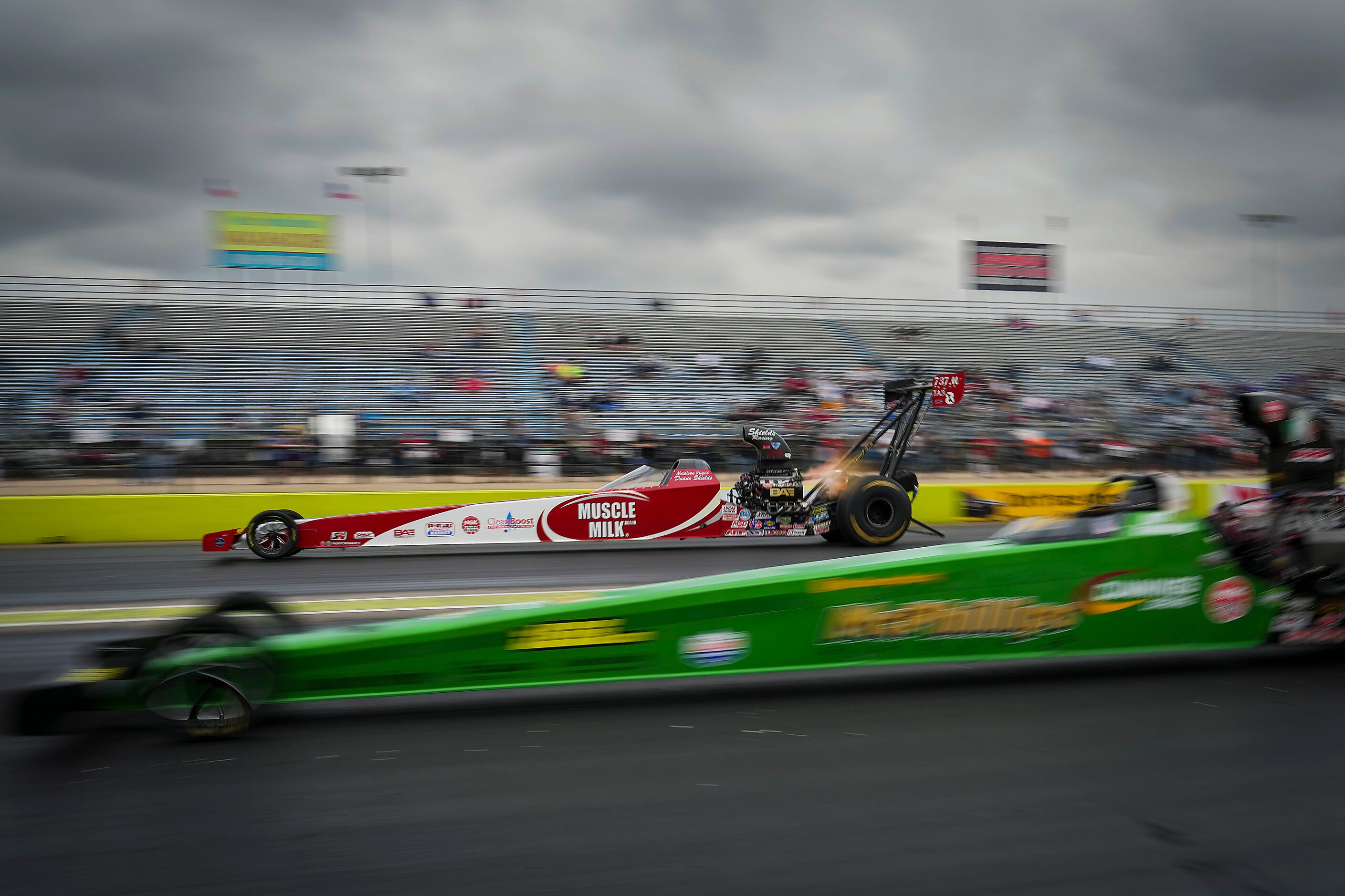 Madison Payne (top) races Matthew Cummings in a Top Alcohol Dragster semifinal at the Texas...