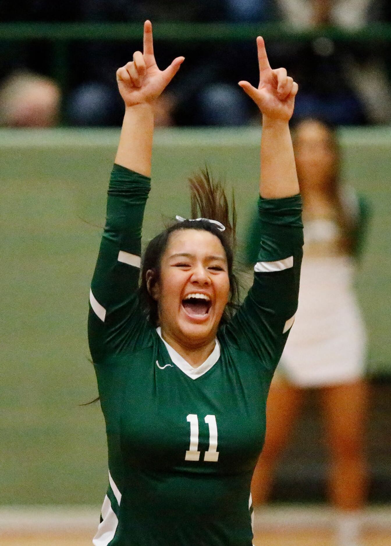 Lebanon Trail High School setter Xuan Nguyen (11) celebrates a point during game one as...