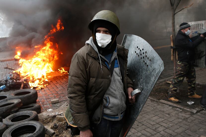 Anti-government protesters man a barricade in central Kiev, Ukraine, Thursday, Feb. 20, 2014. 