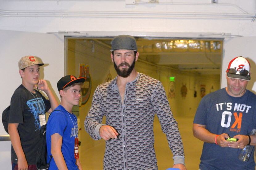 Chicago Cubs starting pitcher Jake Arrieta leaves a news conference wearing pajamas after...