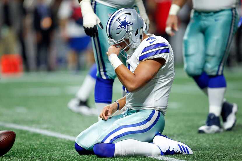 Dallas Cowboys quarterback Dak Prescott (4) takes moment after being sacked hard by Atlanta...