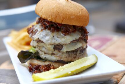 The $19 4x100 Relay Burger at the Dallas Omni Hotel is a quadruple patty with black pepper...