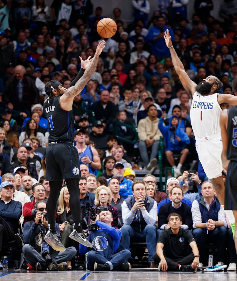 Dallas Mavericks guard Jaden Hardy shoots a three pointer over LA Clippers' James Harden...