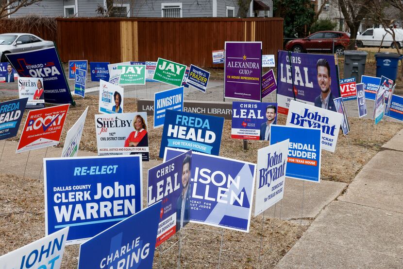 Various campaign signs fill the grass during the first week of early voting outside Lakewood...