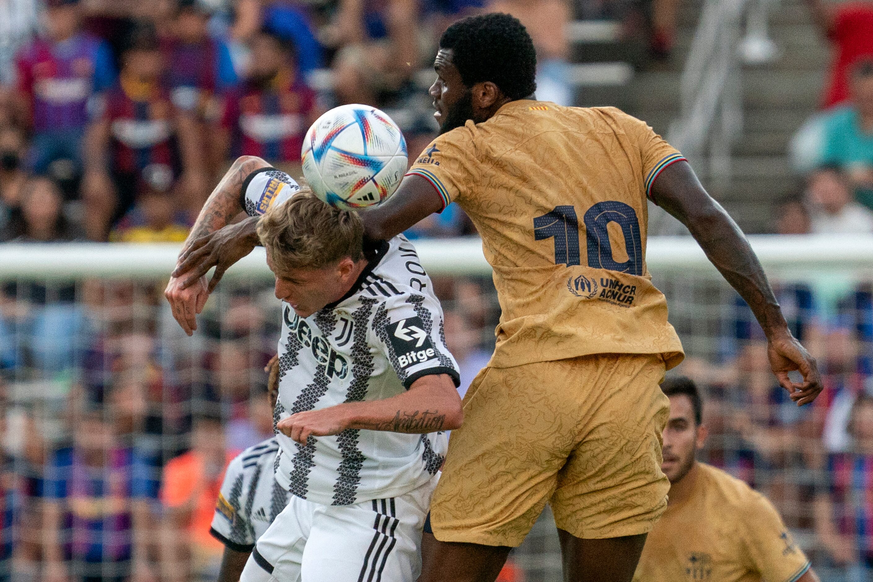 Barcelona midfielder Franck Kessie (19) competes for a header against Juventus midfielder...