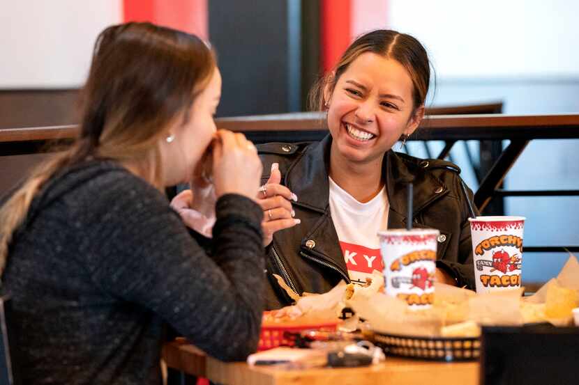 Jessica Molina (right) laughs with her sister Marisa Molina as they share a meal at Torchy’s...