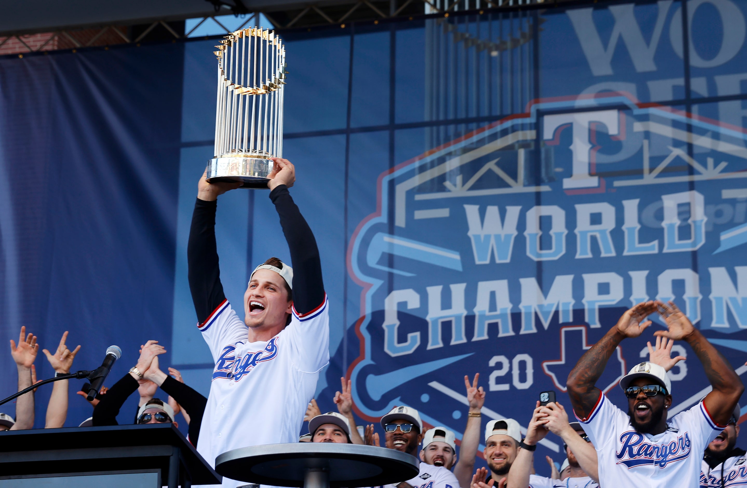 Texas Rangers World Series MVP shortstop Corey Seager hoists the Commissioner's Trophy...