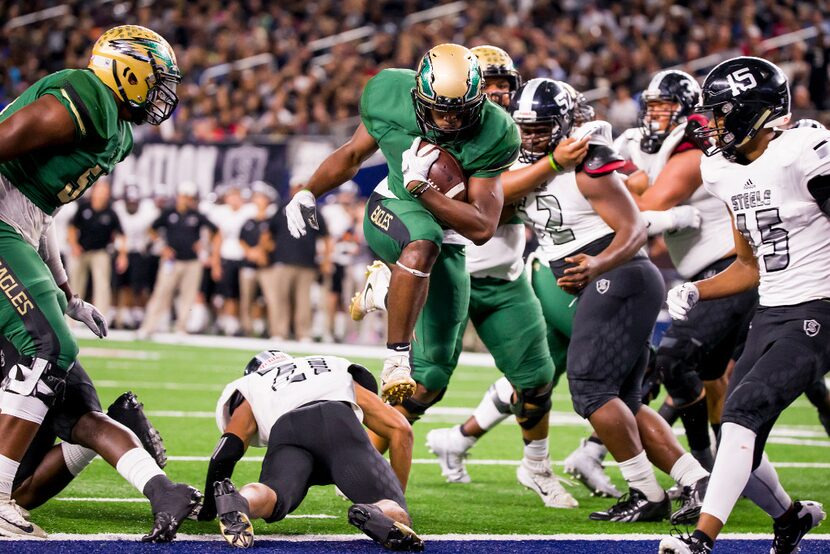 DeSoto running back Kelan Walker (6) scores on a 1-yard touchdown run past Cibolo Steele's...