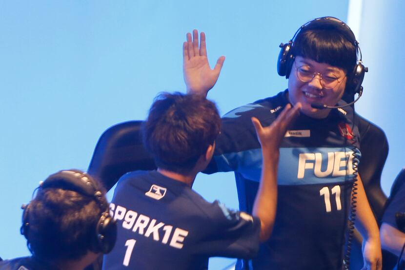 Dallas Fuel's Choi "Hanbin" Han-been, right, exchanges a high-five with teammate Kim...