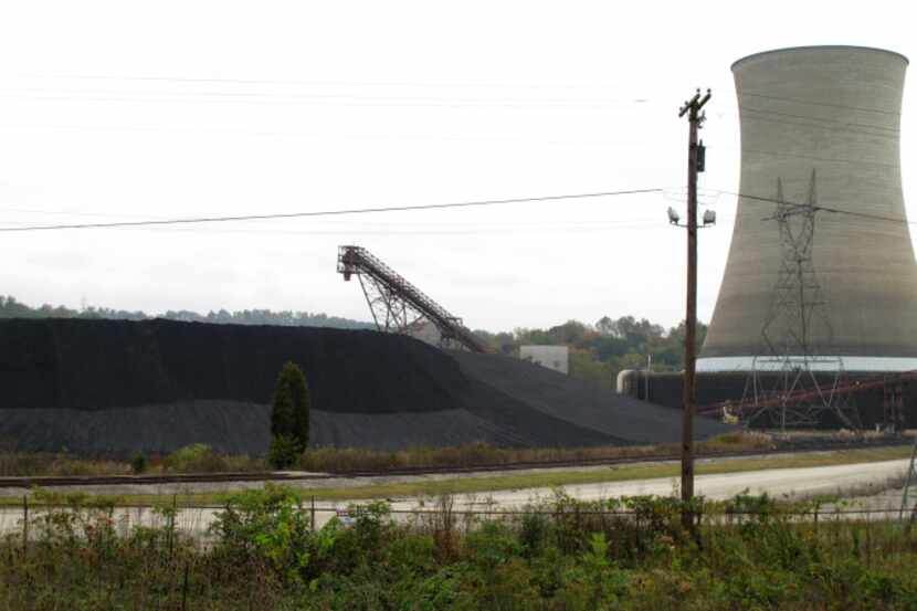 Tons of coal sit next to a Big Sandy power plant unit near Louisa, Ky.
