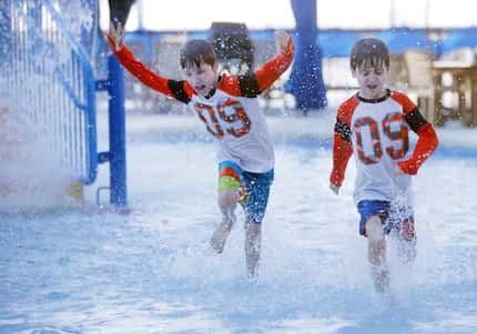 Twin brothers Jace Akin, 7, (right) and Jett Akin get an early glimpse of Epic Waters during...