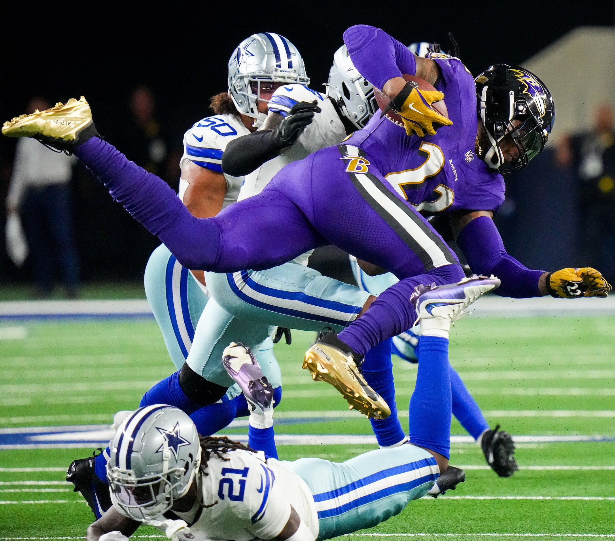 Baltimore Ravens running back Derrick Henry (22) is tripped up by Dallas Cowboys cornerback...