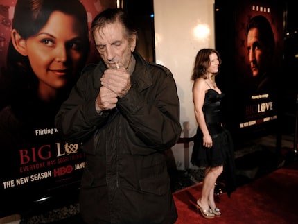 Harry Dean Stanton lights a cigarette on the red carpet.