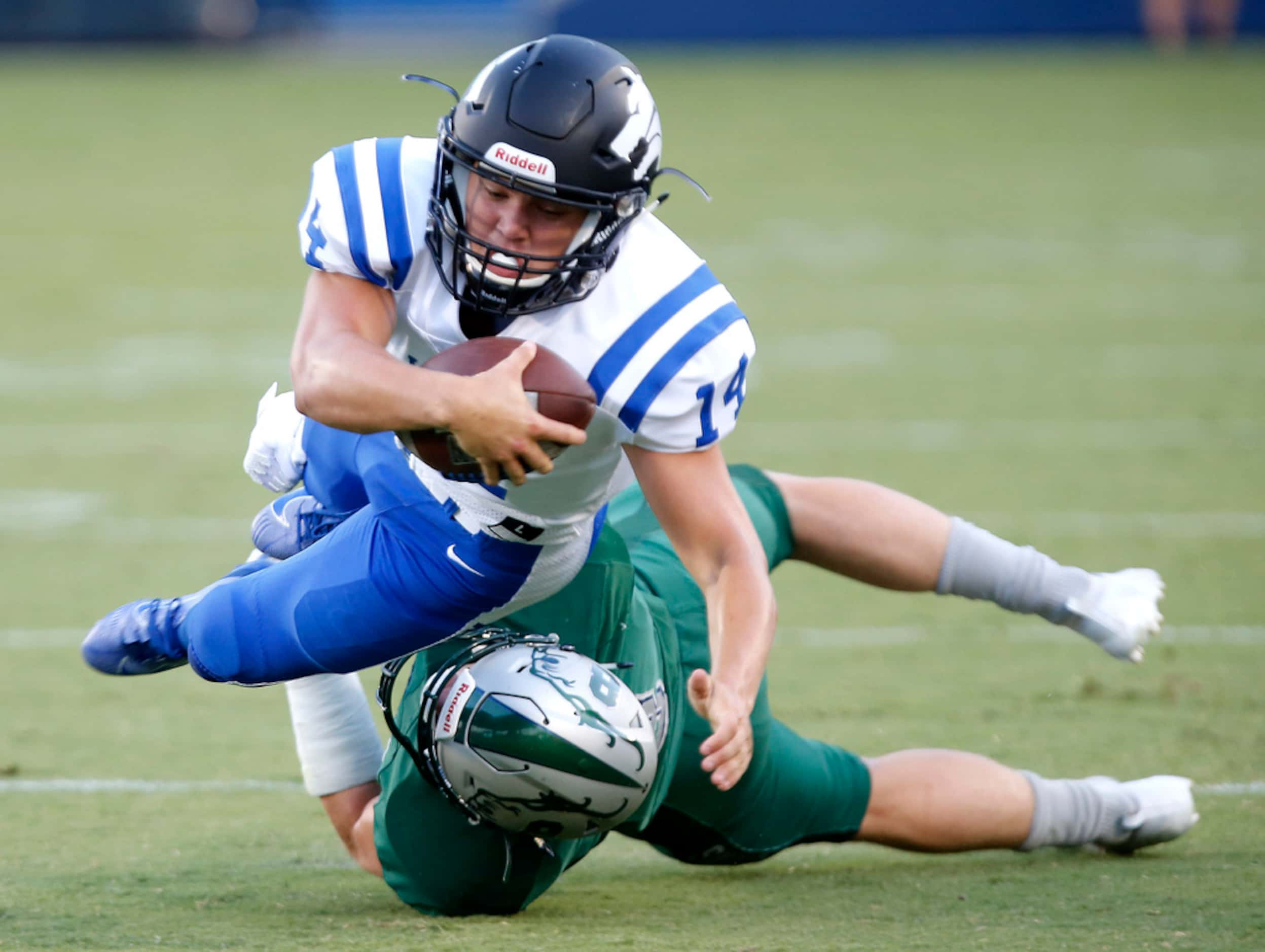 Plano West quarterback Andrew Picco (14) is taken down by Reedy linebacker Michael Swope (8)...