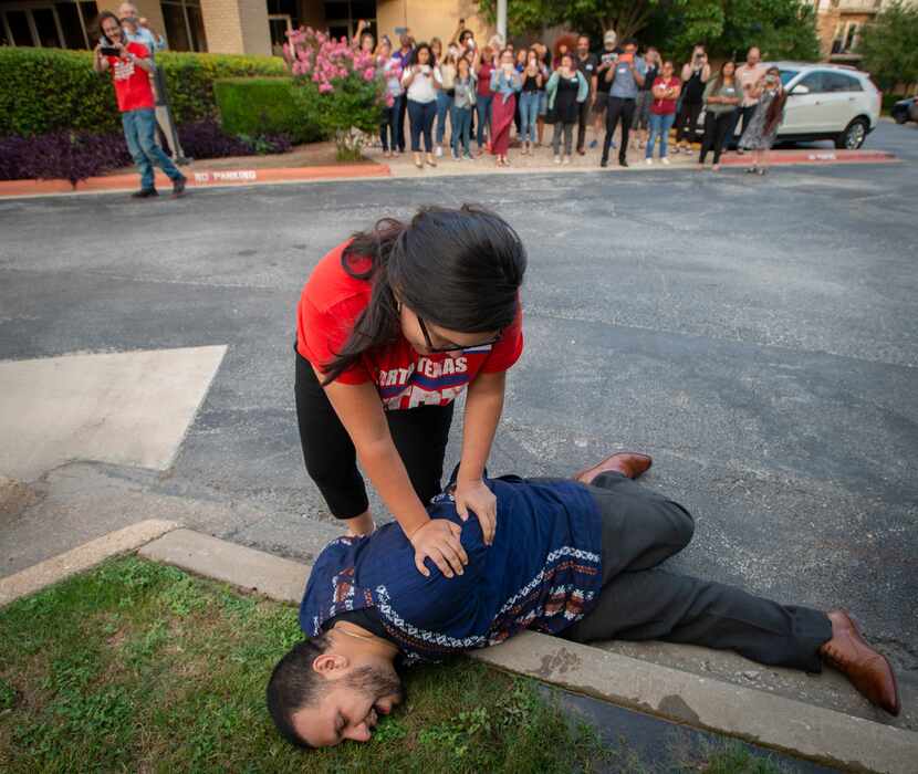 Angelica Andrade and Nicolas Hernandez of the North Texas Dream Team simulated an arrest in...