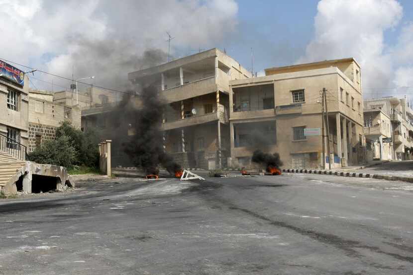 Tires burn along a street in Daraa, south of Damascus, in March 2011. Syrian security forces...