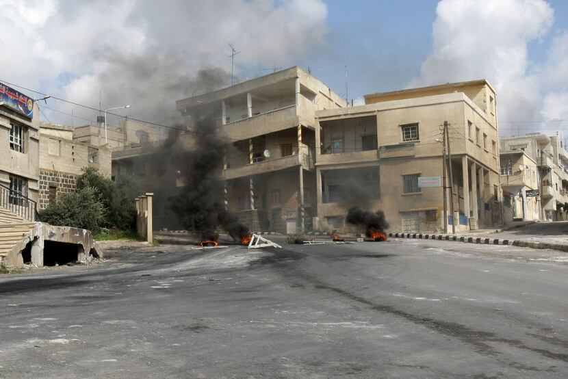 Tires burn along a street in Daraa, south of Damascus, in March 2011. Syrian security forces...