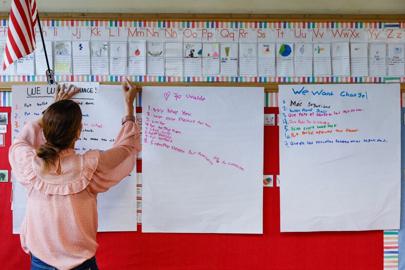 F.P. Caillet Elementary School teacher Michelle Davis puts up poster boards with her...