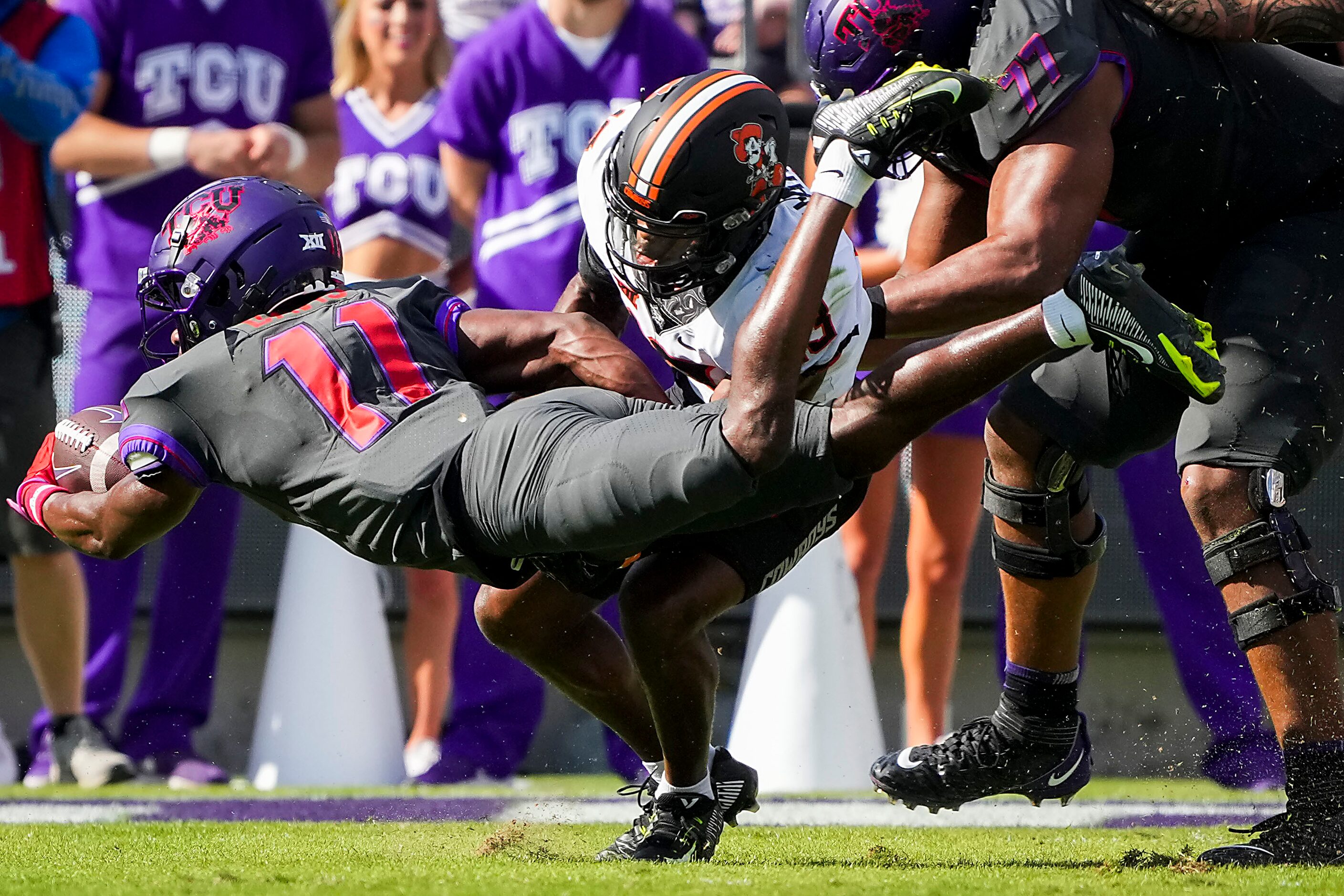 TCU wide receiver Derius Davis (11) is stopped on a fourth down attempt by Oklahoma State...