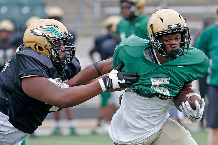 DeSoto running back Tyson Alexander (right) gets away from a defender during practice at...