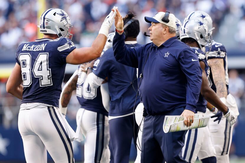 Dallas Cowboys head coach Mike McCarthy gives a high-five to Dallas Cowboys tight end Sean...