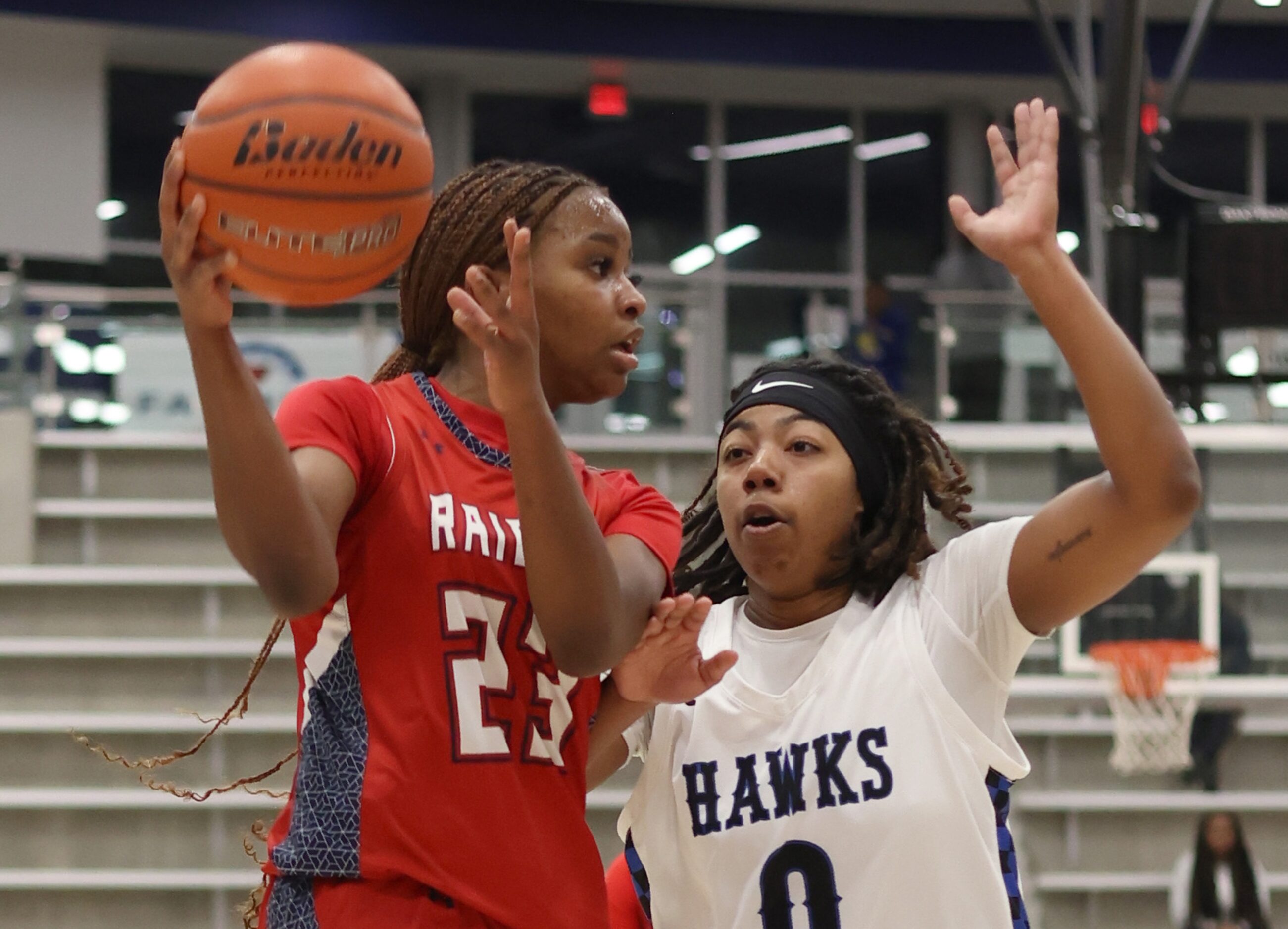 Denton Ryan's Lauryn Stephens (23), left, looks to pass to a teammate around the defense of...