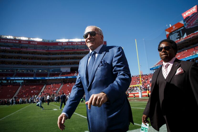 Dallas Cowboys owner Jerry Jones greets fans as the teams warm up before an NFL football...