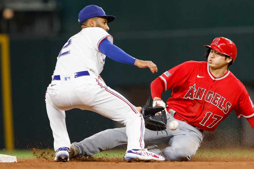Los Angeles Angels designated hitter Shohei Ohtani (17) safely steals second base ahead of a...