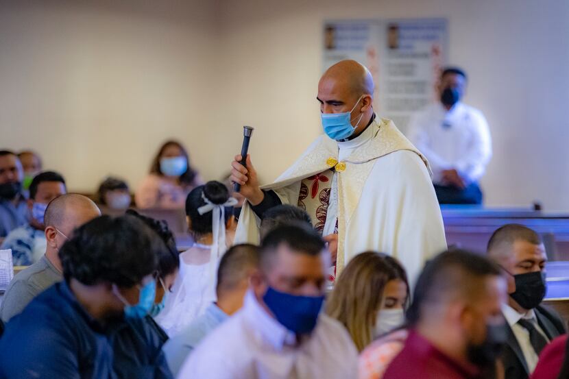 Father Jesus Belmontes blesses his congregation at San Juan Diego Catholic Church in Dallas...