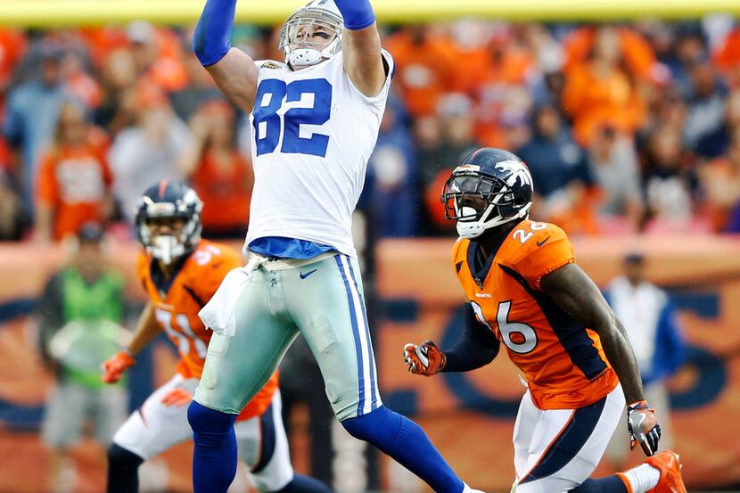 Dallas Cowboys tight end Jason Witten (82) reaches for the catch in front of Denver Broncos...