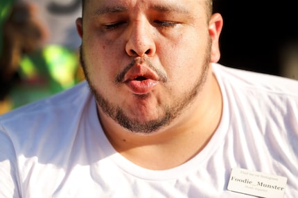 Competitor Louis Silva of Hurst takes a quick breather during the inaugural Fletcher's Corny...