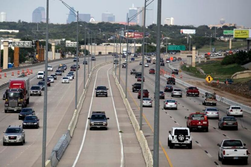 
Cars drive on the Interstate 30 HOV lane near Cockrell Hill Road in Dallas. HOV lanes on...