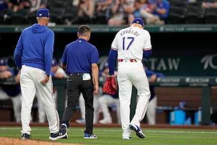 Texas Rangers starting pitcher Nathan Eovaldi (17) walks off the field with pitching coach...