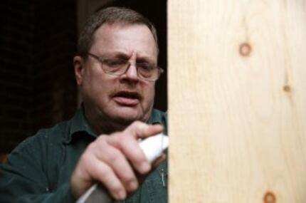  Working on a bathroom repair job, Glenn Billingsley has found work as a handyman. (Rose...
