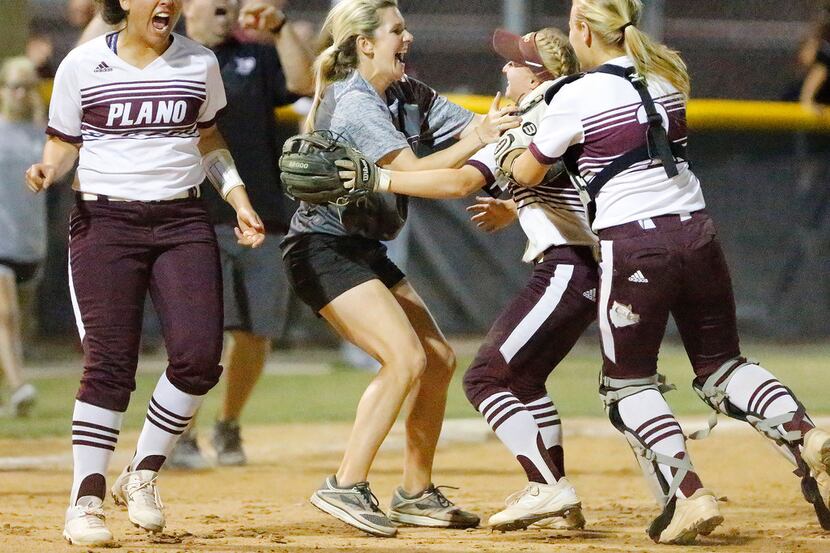 Plano head coach Molly Pipak rushes the field as players celebrate their 10-6 victory over...