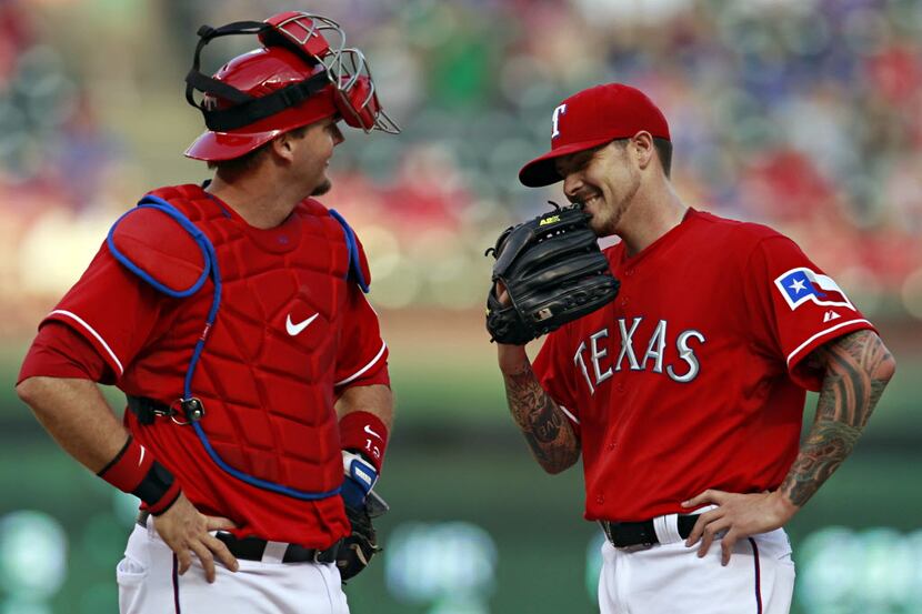 Texas Rangers starting pitcher Travis Blackley (right) and catcher A.J. Pierzynski laugh...